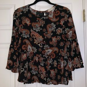 Black fashion top with orange paisley pattern
